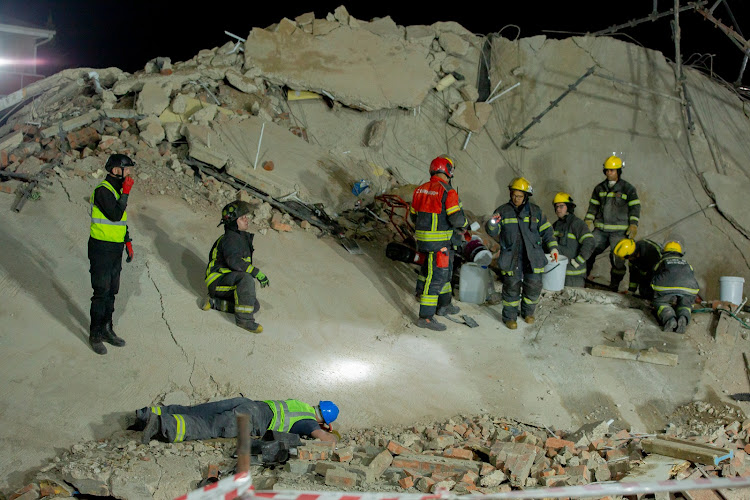 Rescue teams are listening for sounds of life from workers trapped under concrete at the construction site in George.