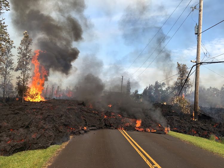 Lava advances along a street near a fissure in Leilani Estates, on Kilauea Volcano's lower East Rift Zone, Hawaii, US, May 5, 2018.