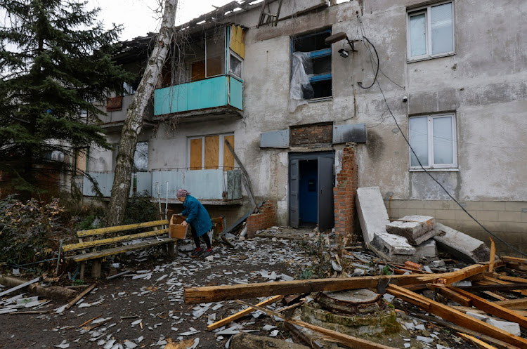 Local resident Ekaterina, 72, collects belongings outside her apartment block, which was damaged by a Ukrainian military strike in the course of Russia-Ukraine conflict, in the settlement of Luganske in the Donetsk region of Russian-controlled Ukraine on March 30 2024.