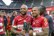 Lionel Mapoe (L) and Elton Jantjies of the Emirates Lions pose for a photograph after the Super Rugby match the Vodacom Bulls at Emirates Airline Park on July 14, 2018 in Johannesburg, South Africa. 
