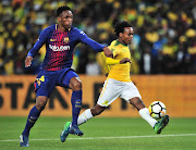 Percy Tau of Mamelodi Sundowns challenged by Yerry Mina of Barcelona during the 2018 Mandela Centenary Cup Friendly match between Mamelodi Sundowns and Barcelona at FNB Stadium, Johannesburg on 16 May 2018.