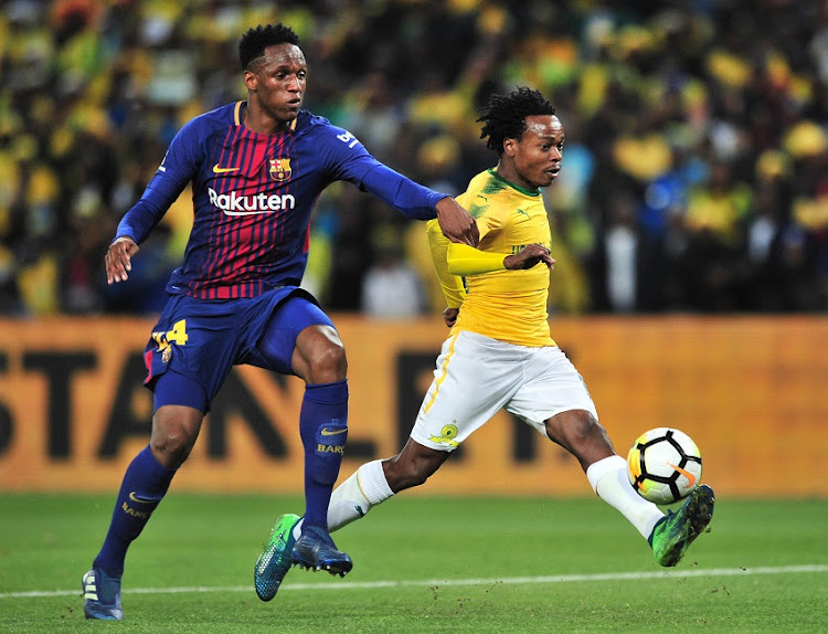 Percy Tau of Mamelodi Sundowns challenged by Yerry Mina of Barcelona during the 2018 Mandela Centenary Cup Friendly match between Mamelodi Sundowns and Barcelona at FNB Stadium, Johannesburg on 16 May 2018.