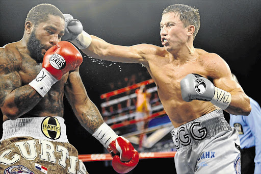 Undefeated Gennady Golovkin, left, lands a heavy punch on Gabriel Rosado in their fight last year. Golovkin takes on Daniel Geale this weekend. File photo