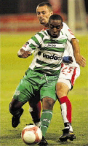 Hero: Bloemfontein Celtic's Patrick Malokase dribbles past Ajax Cape Town's Brett Evans during their PSL match recently. Malokase is expected to give Chiefs defence a hectic time this afternoon.07/02/07. \n Photo by Tertius Pickard. © Gallo Images. \n