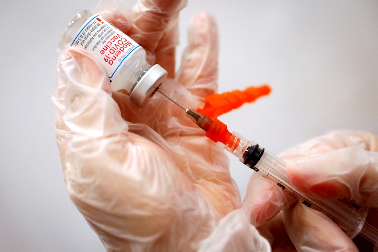 A healthcare worker prepares a syringe with the Moderna Covid-19 vaccine.