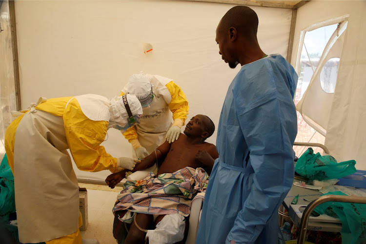 Medical stuff and an Ebola survivor treat an Ebola patient in a medical centre in Beni, Democratic Republic of Congoon on March 31, 2019.