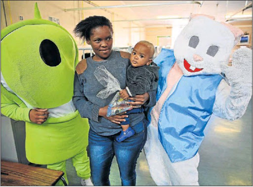HAPPY DAY: Pick n Pay's Stickeez mascott joined the Easter Bunny in bringing cheer (and treats) to children at Cecilia Makiwane Hospital. Ntombovuyo Mbuyazwe and her son Sokholosa, pictured, were happy to be spoilt yesterday. Picture: MARK ANDREWS