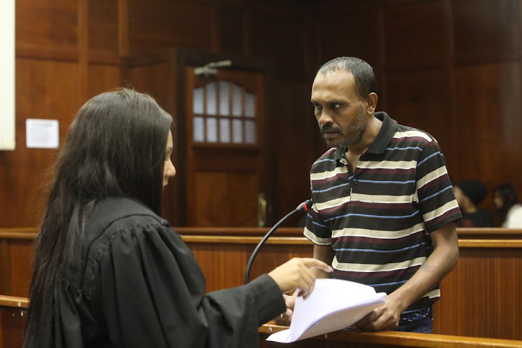 Triple-murder accused Collin Pillay speaking to his attorney, Amanda Hulley, in the Durban high court.