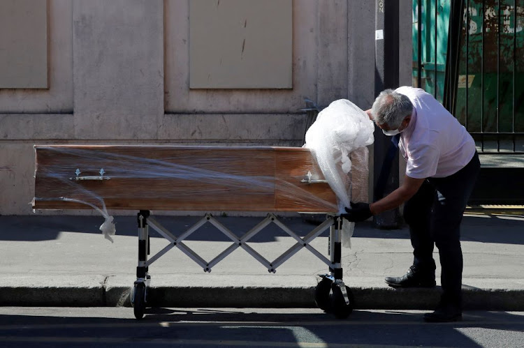 An employee delivers a coffin at the Fondation Rothschild retirement home in Paris, on March 25 2020, where 16 residents have died and 81 have been infected with Covid-19 as the spread of the coronavirus continues in France.