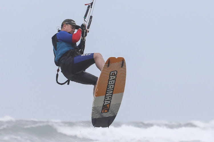 A kite surfer is lifted into the air by wind. The sport is not considered high risk for death.