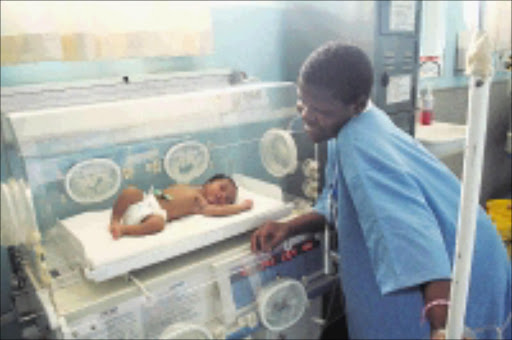 LUCKY TO BE ALIVE: Tinyiko Khoza with her baby Nhlanhla at the Mapulaneng Hospital. The little girl survived more then 10 hours under a rubbish bin.225/11/2008. Pic. Andrew Hlongwane. © Sowetan.