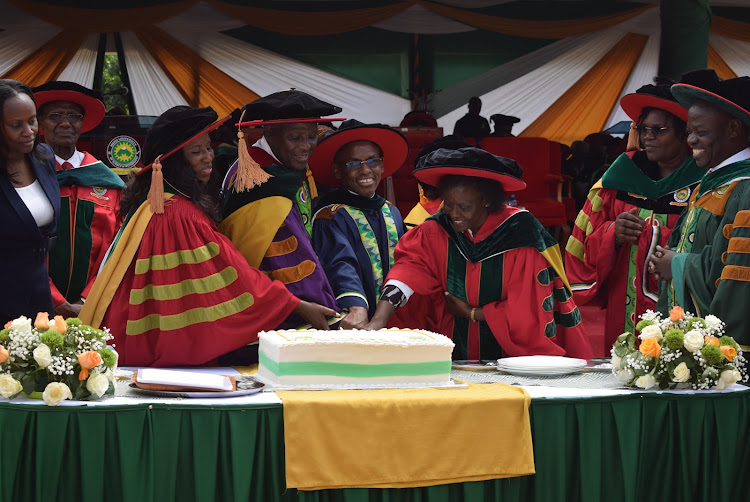 from Left PS State department of University Education Beatrice Muganda,Equity CEO James Mwangi and Safaricom CEO Peter Ndegwa cut cake to celebrate Ndegwa's unaguration