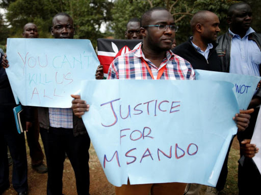Demonstrators from the Civil society group hold placards as they protest over the death of Chris Msando, a senior Kenyan election official who was found murdered in Nairobi, Kenya, August 1, 2017. /REUTERS