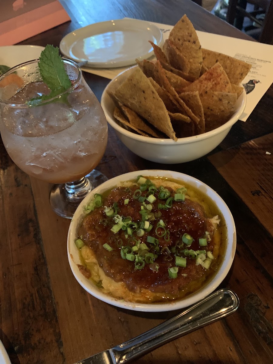 The fish and chips dip, as of September 1st 2022. Delicious smoked fish, with a sweet peach puree on top, and homemade corn chips. Also their zero alcohol peach shrub cocktail.