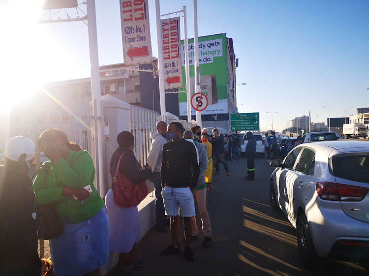 Scores of masked customers line up outside Liberty Liquors in Durban on Monday morning to get their hands on much-awaited alcohol.