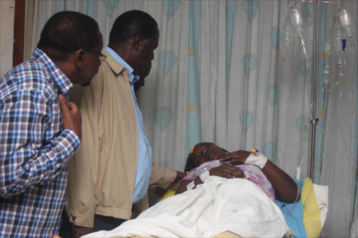 Siaya Senator James Orengo with Former Prime Minister Raila Odinga consoles Mercy Chepkorir, one of the Causalities who survived the attack at the Kenyatta National Hospital yesterday. Photo/Enos Teche.