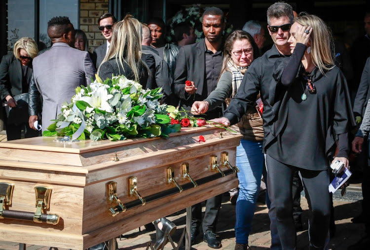 Mourners pay their respects at the memorial service for slain footballer Marc Batchelor on Thursday.