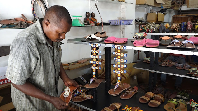 Michael Nzuki shows some of the products made from recycling materials in Malindi town