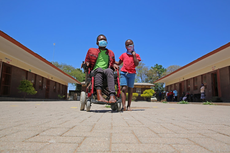 Itumeleng Swartland arrived at Mpongele Primary School in a wheelchair, accompanied by his son, Nana, where he was to cast his vote for the local government elections.