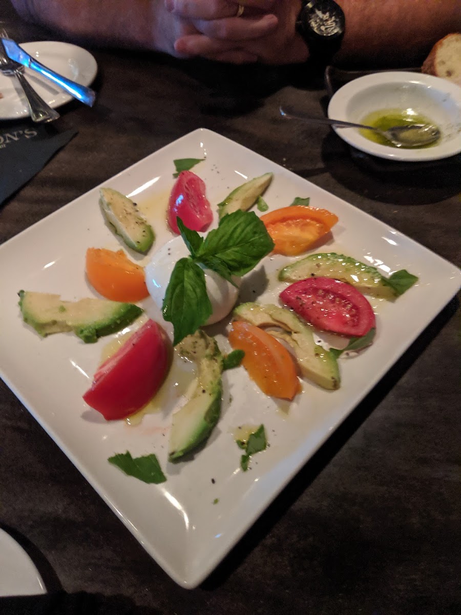 Appetizer, OMG delish! Fresh mozzarella, avacado, heirloom tomatoes...