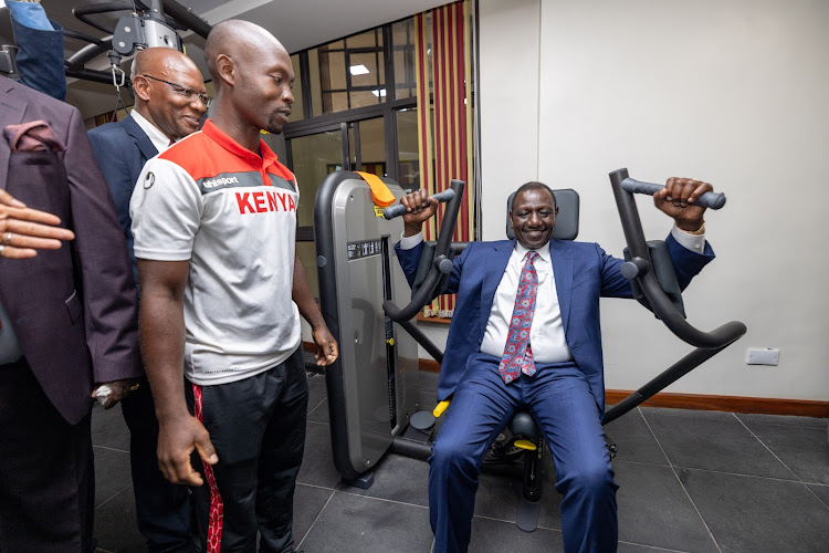 President William Ruto tries gym equipment at the newly opened Bunger Tower on April 25, 2024.