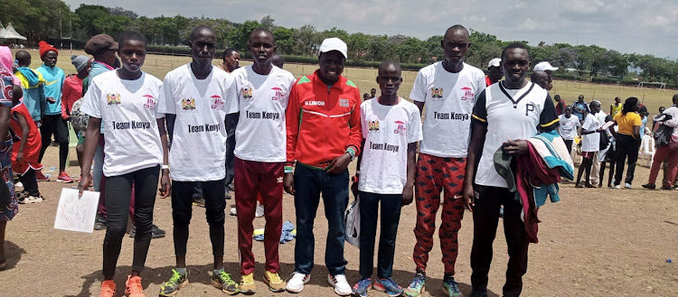Boniface Limo, posing with some of the athletes who will take part in the ISF Cross country this weekend