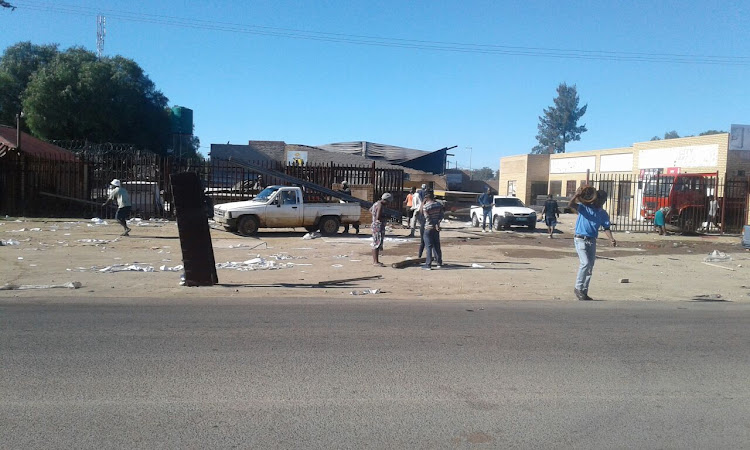 People seen leaving a looted warehouse in Stateng as Mahikeng protests calling for North West Premier Supra Mahumapelo to step down continue.