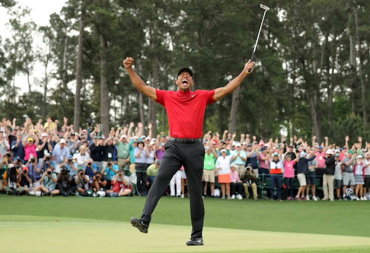 Tiger Woods celebrates on the 18th hole after winning the 2019 Masters.