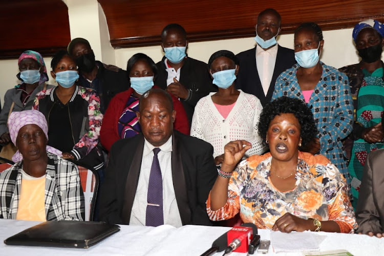 Some of the Nakuru IDPs with their coordinator Lucy Njeri during the press address on Tuesday.
