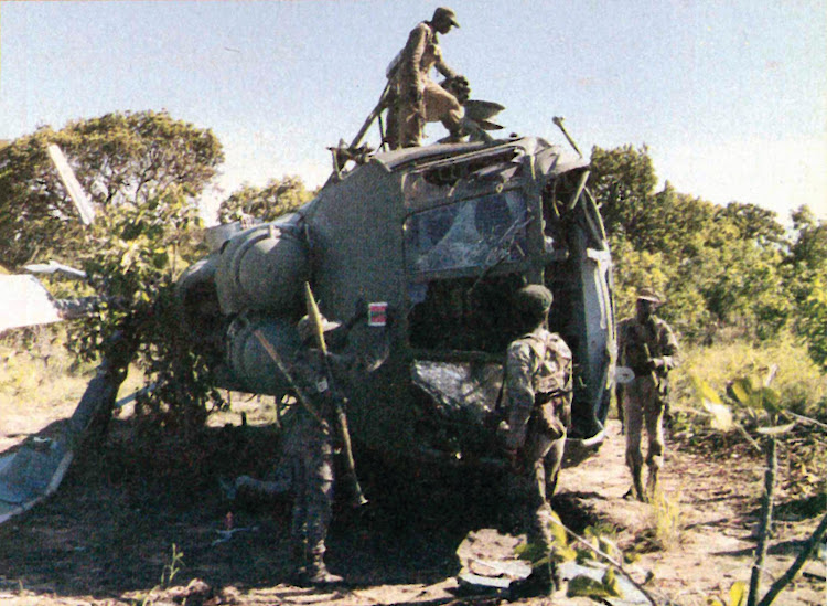 Troops clamber over an Angolan Air Force, Russianbuilt Mi-8 assault helicopter shot down during the battles. This helicopter is codenamed Hip by NATO.