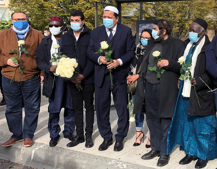 Imam of Drancy Hassen Chalghoumi, president of the Conference des imams de France, and a delegation gather with flowers near the Bois d'Aulne college to pay tribute to Samuel Paty, the French teacher who was beheaded on the streets of the Paris suburb of Conflans-Sainte-Honorine, France, October 19, 2020.