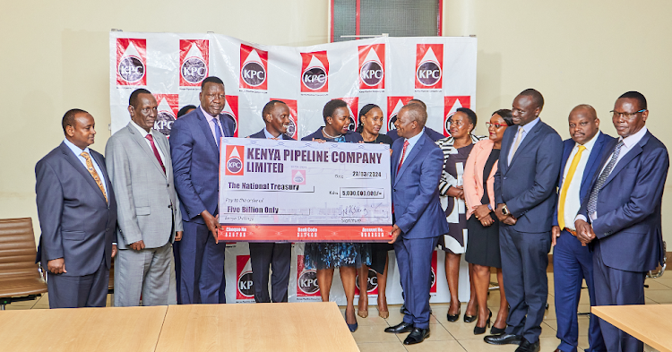 Energy and Petroleum CS Davis Chirchir (third left) and Petroleum PS Mohamed Liban (second left) hands over an interim dividend cheque of Sh5 billion to National Treasury CS Njuguna Ndung’u as KPC Chairman Faith Bett-Boinett and MD Joe Sang (center), KPC directors and officials from the National treasury look on/HANDOUT