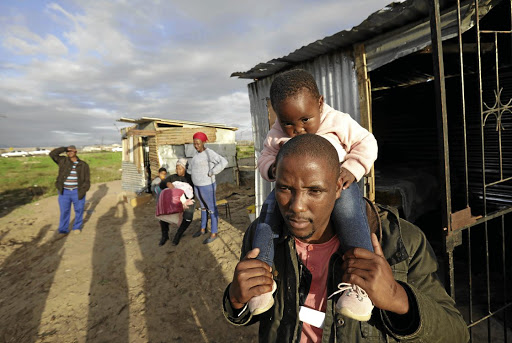 Bulelani Qolani, with daughter Misokuhle Mqhamane, at their home in eThembeni informal settlement. It was rebuilt within days of being demolished by City of Cape Town officials on July 1 2020.