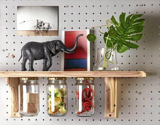 Adding glass jars to a store-bought shelf is an easy way to add extra storage.