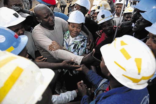 IN THE MIDST OF GRIEF: Minister of Mineral Resources Susan Shabangu and Harmony Gold chairman Patrice Motsepe leave Harmony Gold's Doornkop mine on the West Rand after addressing workers