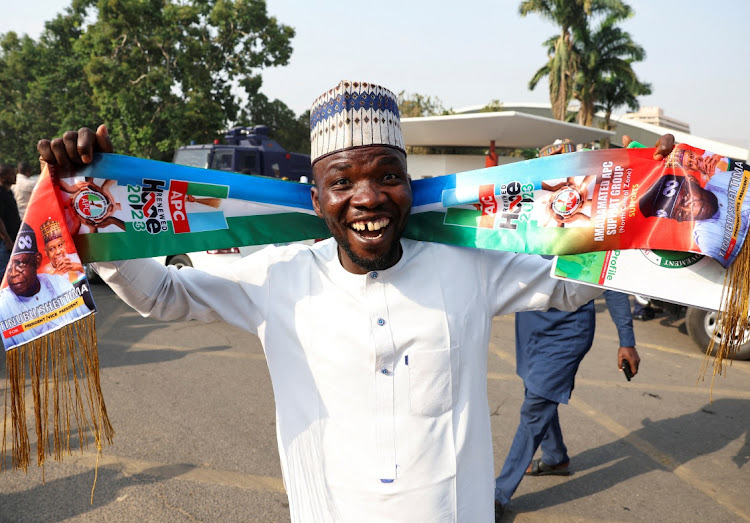 An All Progressives Congress (APC) supporter celebrates after the Independent National Electoral Commission declared the presidential candidate of the APC, Bola Tinubu as the winner of the 2023 presidential election, in Abuja, Nigeria.