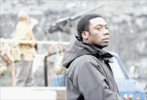 Filming for a film based on the smash hit TV series 24, starring Kiefer Sutherland, at a quarry near Cape Town this week. Left is local Los Angeles-based actor Hakeem Kae-Kazim, who burst onto the movie scene with Hotel Rwanda, who portrays a rebel leader in the 24 filmPic. TERRY SHEAN 19/06/2008. © ST