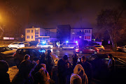 Rescue services gather at the site of a fire which broke out next to an 'escape room' in Koszalin, Poland, on January 4 2019. Five girls at the game venue died.