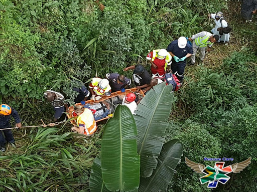 rescue team carry an injured man up a steep embankment after, according to paramedics on the scene, he was thrown off a bridge in Durban Picture: Rescue Care