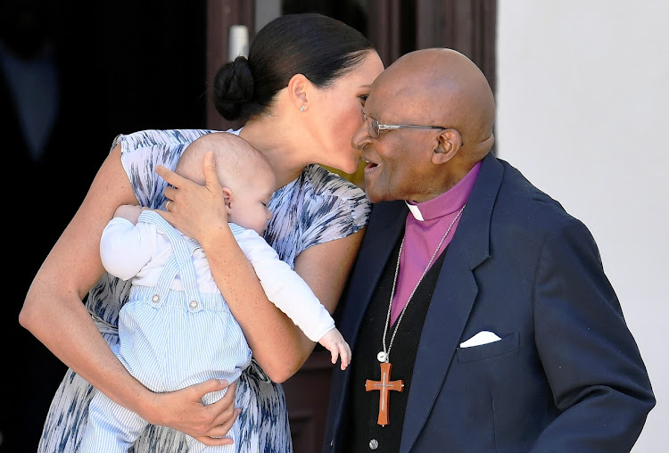 The Duchess of Sussex speaks to Archbishop Emeritus Desmond Tutu as she holds her baby son Archie in Cape Town on September 25 2019.
