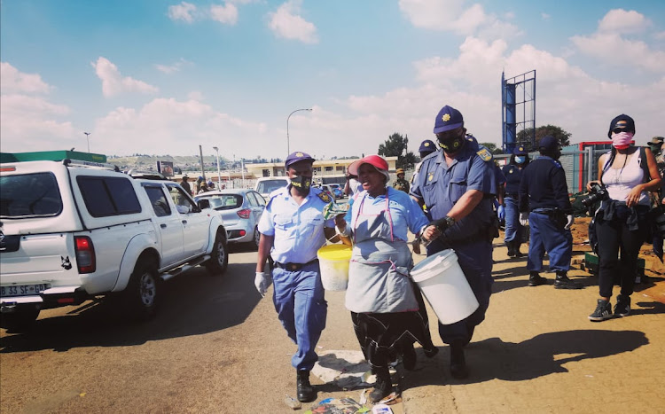 Police arrest street vendor Thandi Thabethe in Soweto for selling atchar without a permit during the lockdown. The writer says for those who are impoverished, the economics of an anti-black capitalist system means risking arrest and police brutality to feed a family right now.