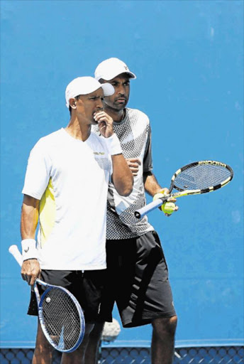 RACQUET READY: South Africa’s Raven Klaasen and his US doubles partner Rajeev Ram were knocked out of Wimbledon yesterday in a thrilling semi-final. Here they talk tactics in their first round match of the 2016 Australian Open in Melbourne in January Picture: GETTY IMAGES