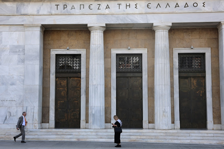People walk in front of Bank of Greece in central Athens, Greece. File photo: LOUISA GOULIAMAKI/REUTERS