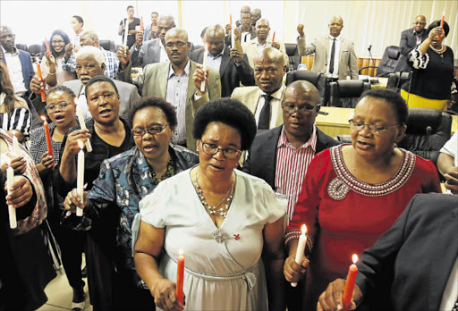 NO MORE: ADM executive mayor Nomfusi Nxawe, front, with her council members as they light candles in support of the campaign to end violence against women and children Picture: MICHAEL PINYANA