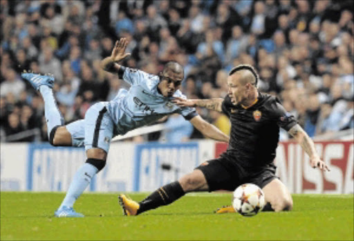 BATTLE: Manchester City's Fernandinho, left, and Roma's Radja Nianggolan fight for the ball in Tuesday's Champions League match PHOTO: PAUL ELLIS/afp