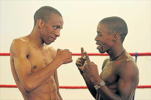 FISTS WILL DO IT: Thembelani Maphuma, left, and Lindile Tshemese square off ahead of their SA junior-bantamweight crown bout at the Mdantsane Indoor Centre tomorrow Picture: SIBONGILE NGALWA