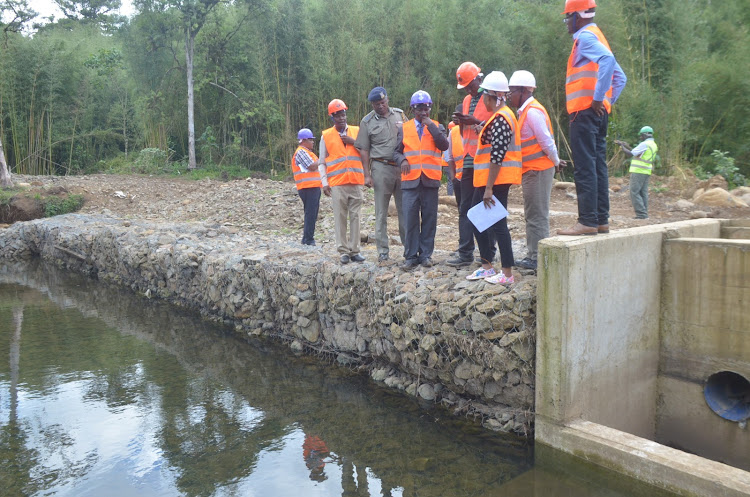 Members of Murang’a County Development Committee at Gatango water project in Mathioya on Wednesday.
