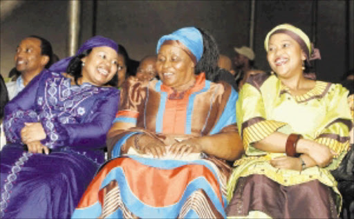 GETTING ALONG: Nompumelelo Ntuli shares a joke with President Jacob Zuma's first wife, Sizakele Khumalo, and wife-to-be Thobeka Madiba. Pic: Simphiwe Nkwali. 06/06/2002. © Sowetan. Jacob Zuma the South African President had a party at his hometown in Nkandla celebrating his victory as the South African President. Jacob Zuma's wifes sharing alight moment from left is Nompumelelo Ntuli, Sizake Zuma and Thobeka Mabhija dancing Picure: SIMPHIWE NKWALI/ 06/06/2002