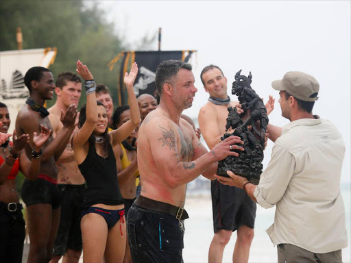 Survivor SA Team Fish collects a prize after winning a challenge in the latest edition of Survivor SA.