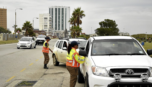 A motorist endangered a traffic cop's life when she tried to speed away while being issued a ticket for being on a cellphone while driving.